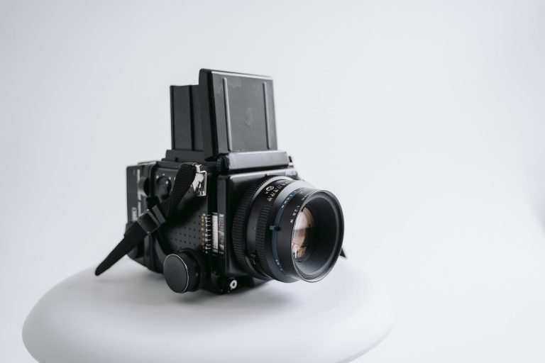 a medium format film camera on a white surface