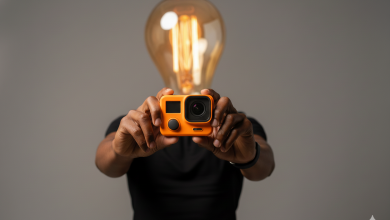 Phil A. Ment hold up an orange action camera.